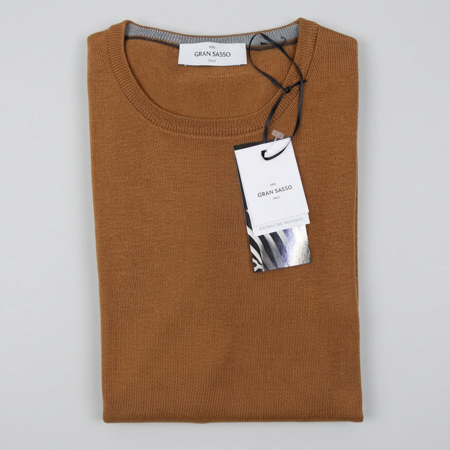 A folded brown knit sweater with a black drawstring and a white Gran Sasso brand hangtag, displayed on a light gray background.