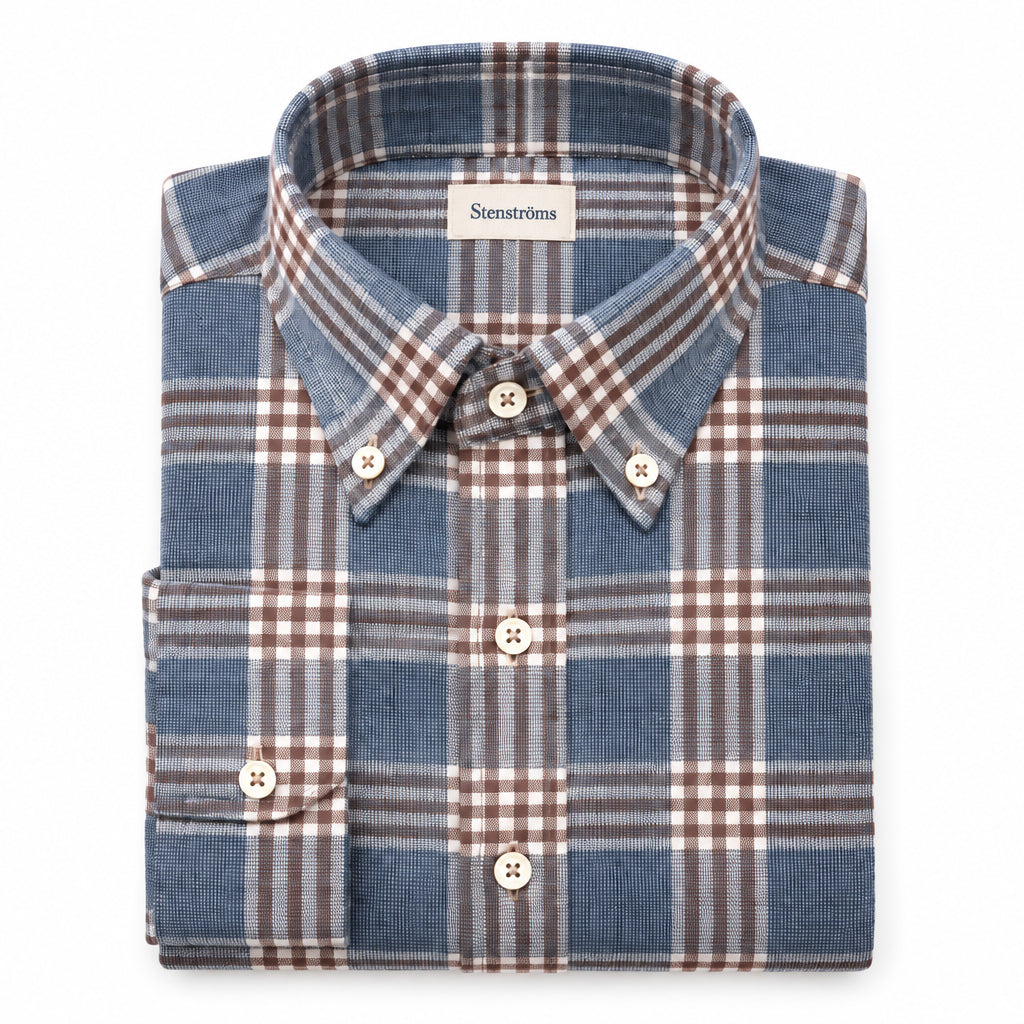 Close-up of a plaid shirt with a focus on the collar and buttons.