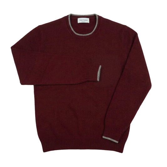 A maroon knit crewneck sweater with gray ribbed trim on the collar, sleeve cuffs, and hem, laid flat on a light gray background.