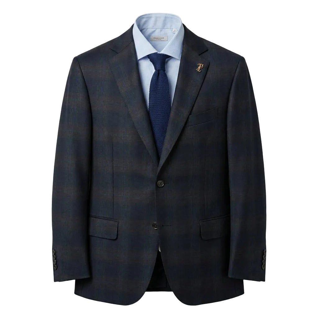 A navy overcheck blazer with a lapel pin, displayed on a mannequin.