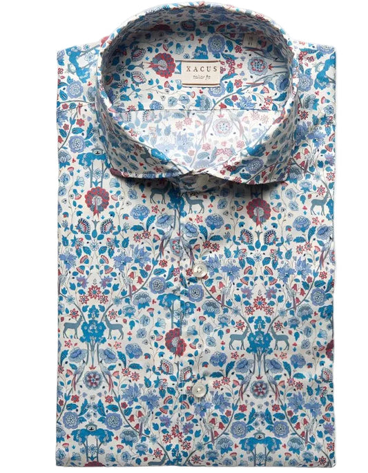 A folded long-sleeve button-down shirt by Xacus, featuring a detailed botanical and animal print in blue, red, and green on a white background.